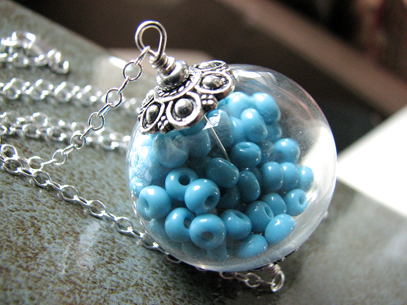 Hollow Glass Pendant Filled With Aqua Beads On A Sterling Silver Chain